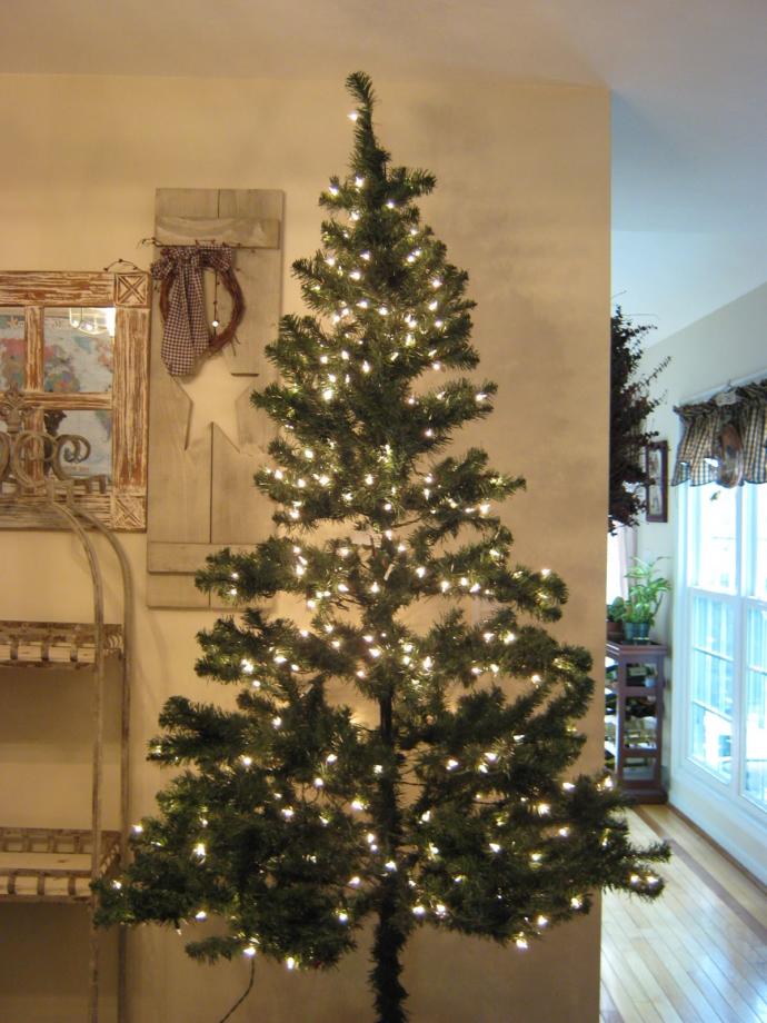 How To Make Your Crappy Artificial Christmas Tree Look Amazing (On a Budget)