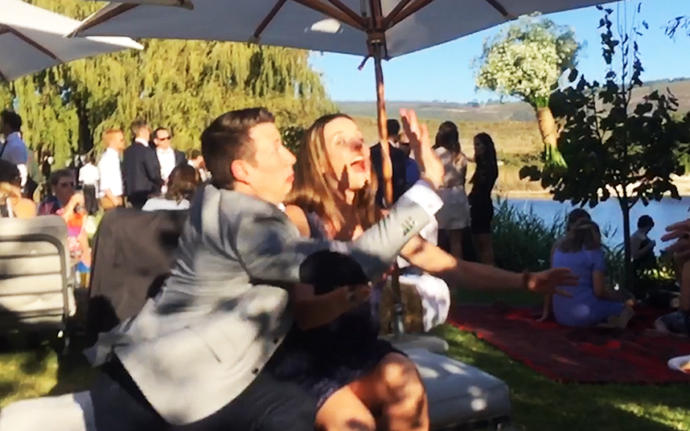 LOL he is blocking her from the bouquet !