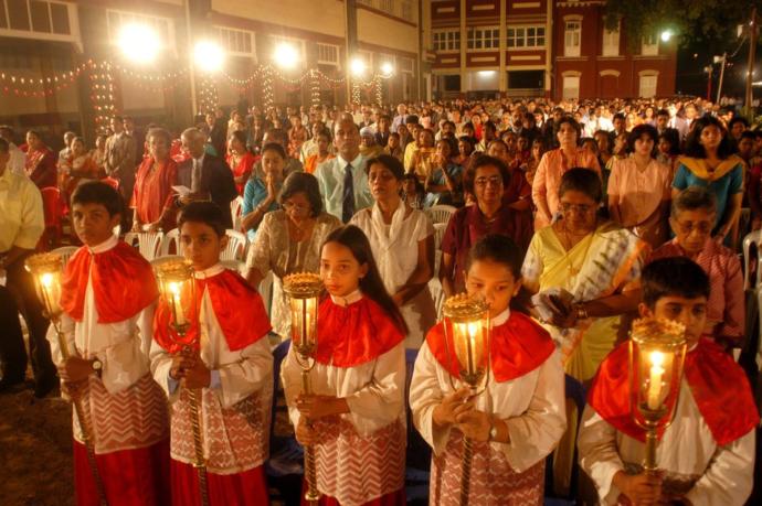 Children holding candles during Midnight Mass