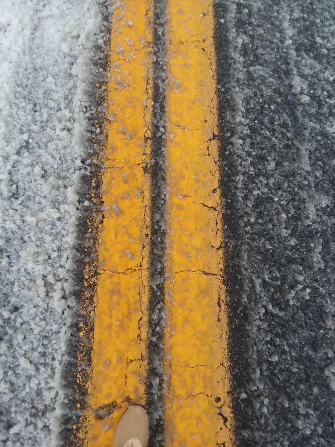 Yellow lines in the middle of the road (and my left shoe)