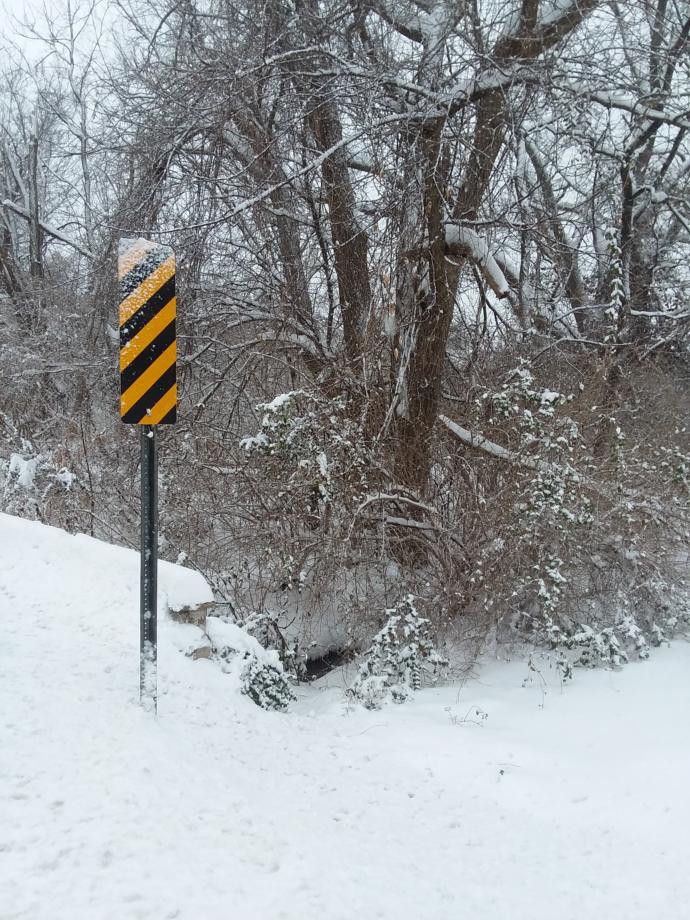 A tiny bridge with caution signs