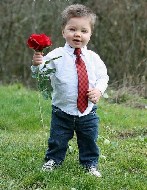 His hands were too small to hold a bouquet. Love his red tie.
