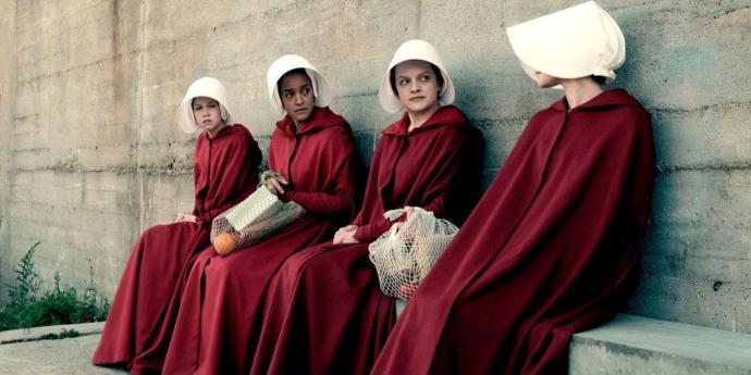 The bridesmaid are forced to wear a red cloak and white hat