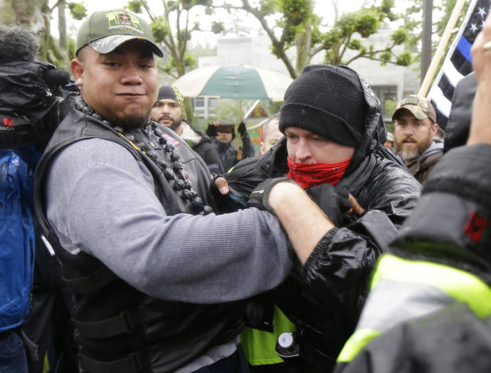 Patriot prayer member restraining a masked antifa troublemaker