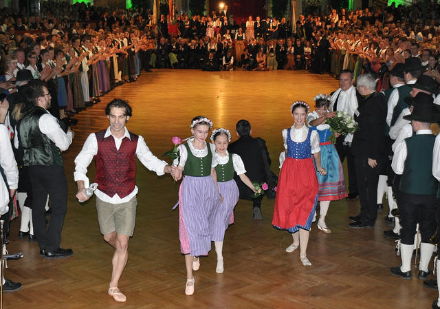 People wearing ballet shoes and the traditional dress of Austria