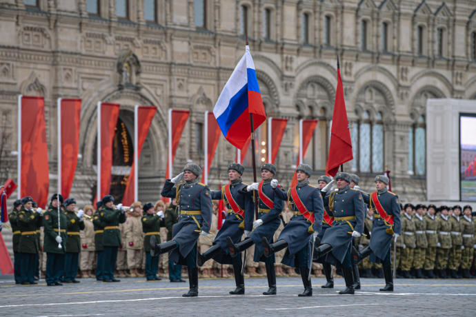 Present day Russian soldiers in great coats and jack boots who also happen to be “goose stepping”.