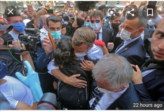 President Macron hugging a Lebanese lady 