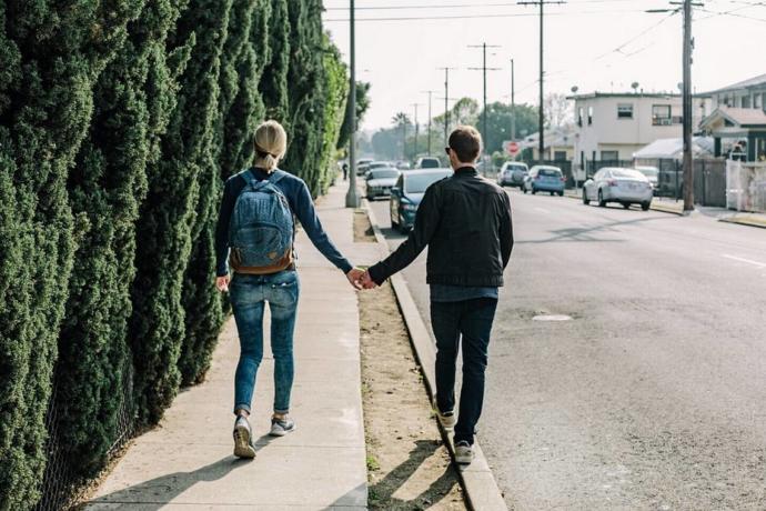 He walks by her on the outside