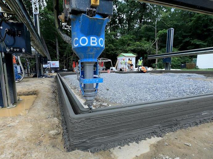 Exterior & interior walls with insulating air gap being "printed" with concrete.