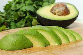 Avocado sliced up on a cutting board