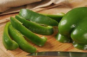 Sliced green bell peppers on a cutting board