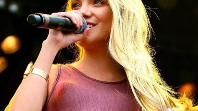 Is the outline of her bra visible?