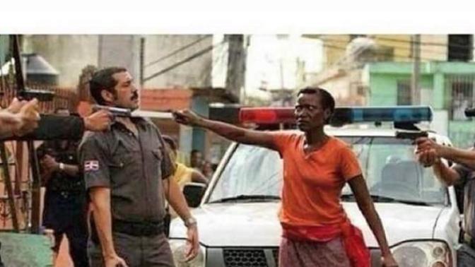 What do you think of this photo of a Haitian mother protecting her son from police abuse?