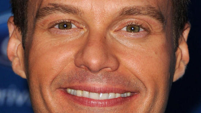 Is Ryan Seacrest actually wearing facial and eye makeup in this picture?