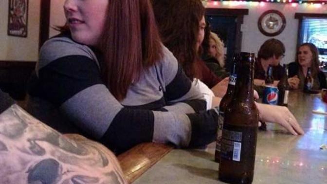 Help!!! Does it look like the second girl (black hair girl) here is married or engaged from the ring on her finger?