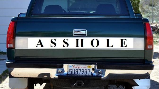 Why would someone put a sign on the back of their truck that says "ASSHOLE"?