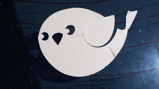 This sticker just appeared on my car.. I didn't put it there.. Anyone recognize it? If it stands for something? If it's a symbol for something?