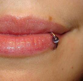 Lip piercing on girls attractive or ugly? Just one lip ring at the side of the bottom lip?