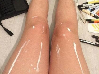 GaGers, do this girl's legs look wet and shiny to you? Or do they just look like they have some streaks of white paint on them?