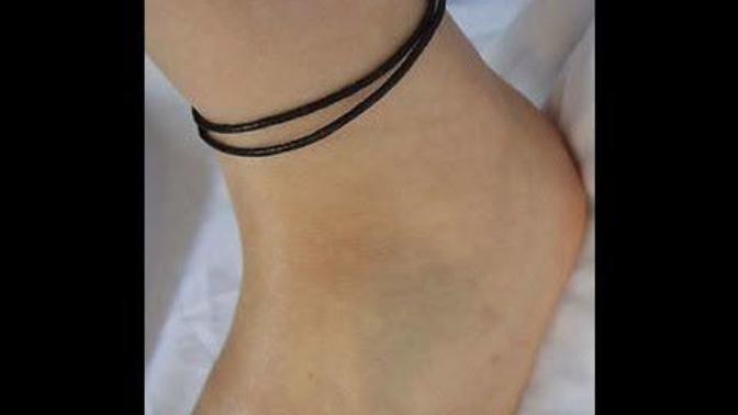 Why do girls wear black or red thread on feet?