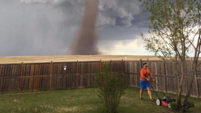 Would you be casually mowing the lawn while a tornado was blowing?