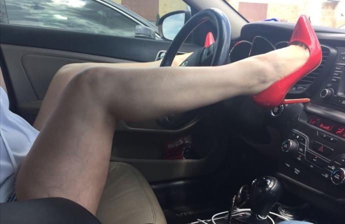 Her newest purchase -- red patent stilettos. You like?