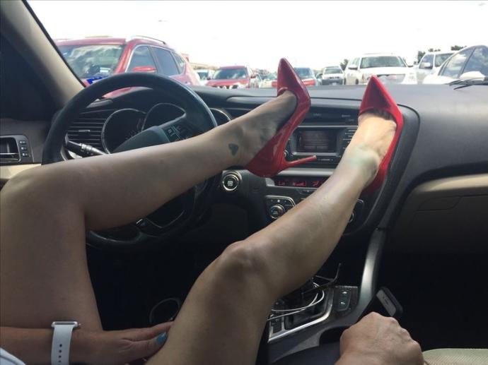 Her newest purchase -- red patent stilettos. You like?