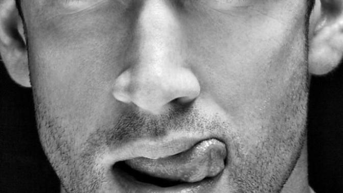 What should I think when a guy licks his lips while talking to me?