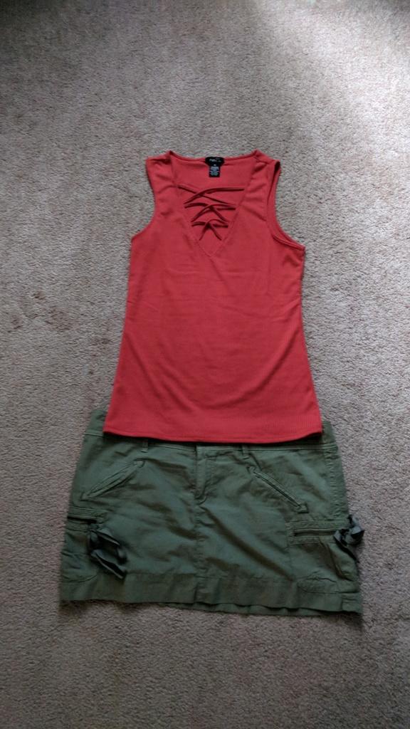 What color top with a grey green skirt?