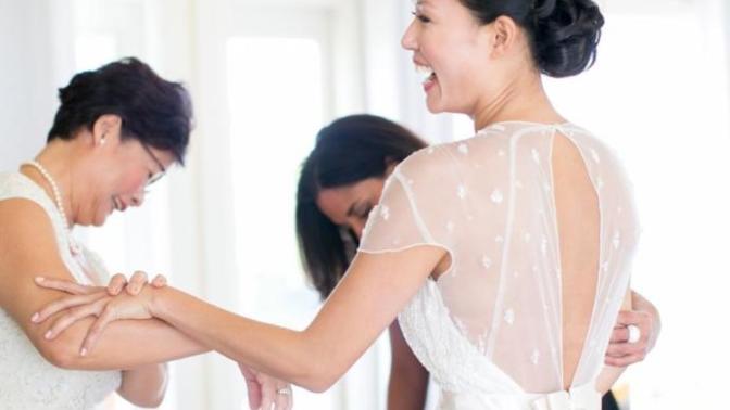 Why are women emotional when trying on wedding dresses?