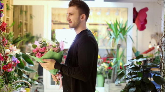 If a girl sends a guy flowers anonymously, what might his reaction be?