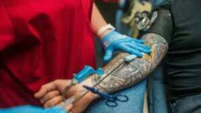 What is the problem with donating blood after getting a tattoo?