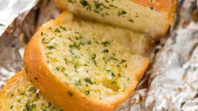 Who invented garlic bread?