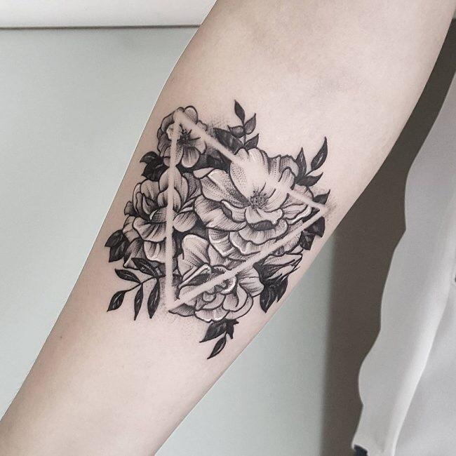 What’s the meaning of a triangle tattoo with a flower inside? GirlsAskGuys
