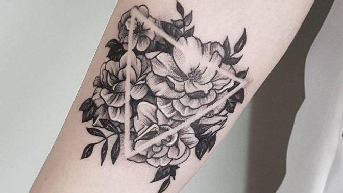 What’s the meaning of a triangle tattoo with a flower inside?