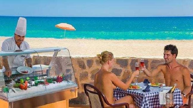How would you react if you turned up to your holiday hotel to find your partner booked a nudist resort?
