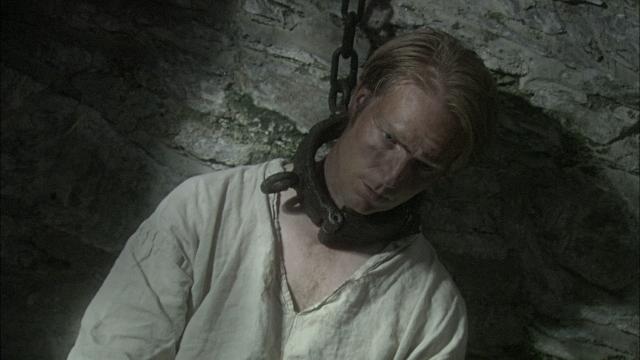 Why did prisoners in the past wear neck irons?