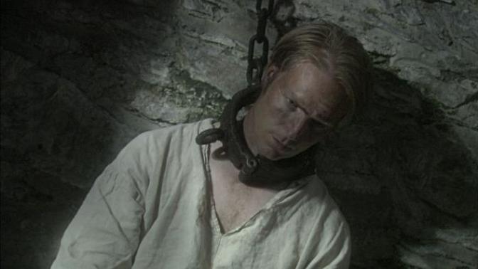 Why did prisoners in the past wear neck irons?