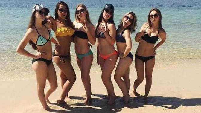 Why do women pose for pictures with one leg bent?