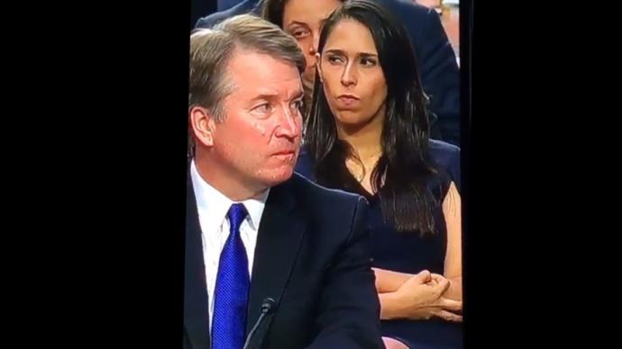 Do you think this woman is making a 'white power' symbol with her fingers?