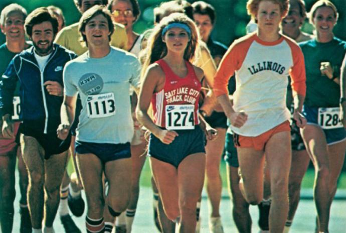 a group of men & women running in short shorts