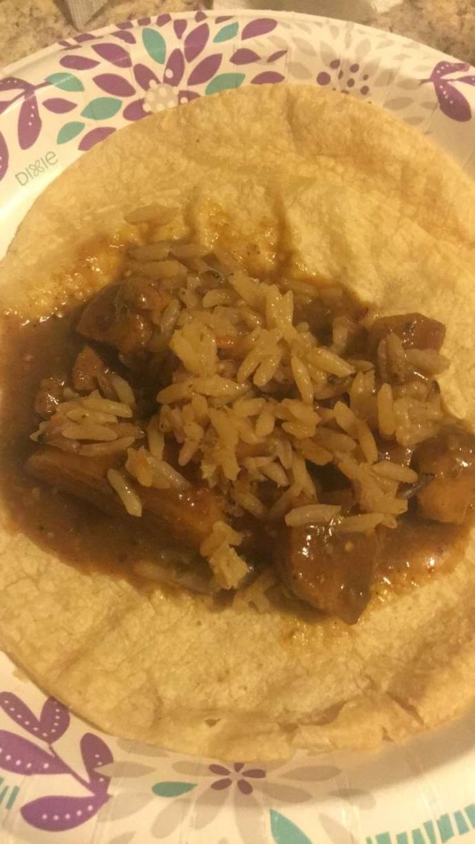 Pork tacos with rice, potatoes, and a spicy sauce