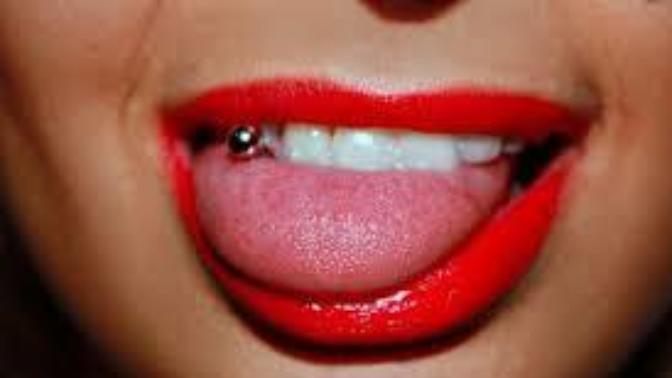 Girls, Does it mean anything that a women visibly plays with her tongue piercing as you talk?
