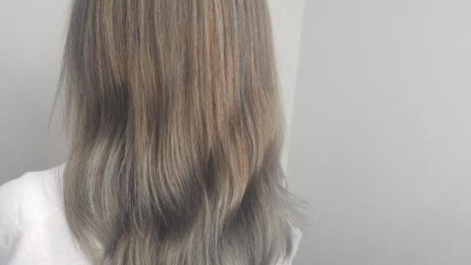 Why is there some orange in my silver hair?