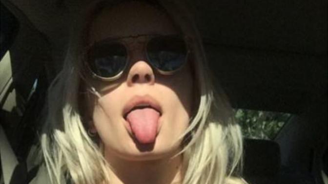 Girls sticking out their tongue?