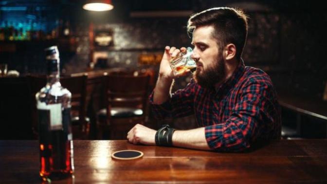 How should one spend their time at a bar if they're going alone?