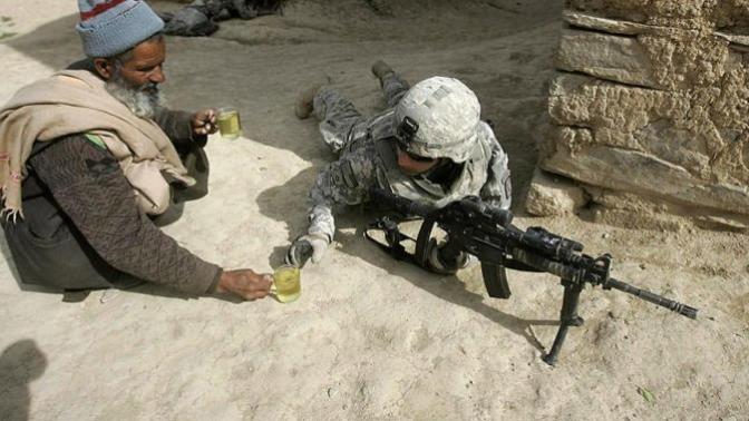 What do you think of this Afghani man sharing tea with a soldier?