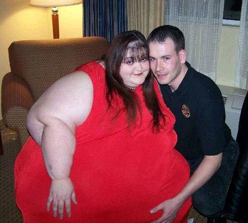 If he wasn't holding up her belly, who knows how low it would sag? THAT's love!