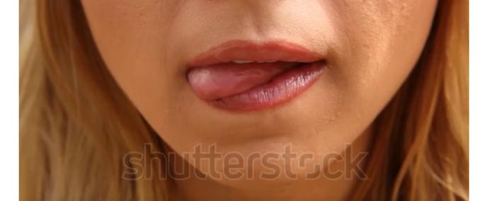 If a woman licks her lips starting at the bottom of her lip while looking at you or at your mouth like in this picture below what does it mean?
