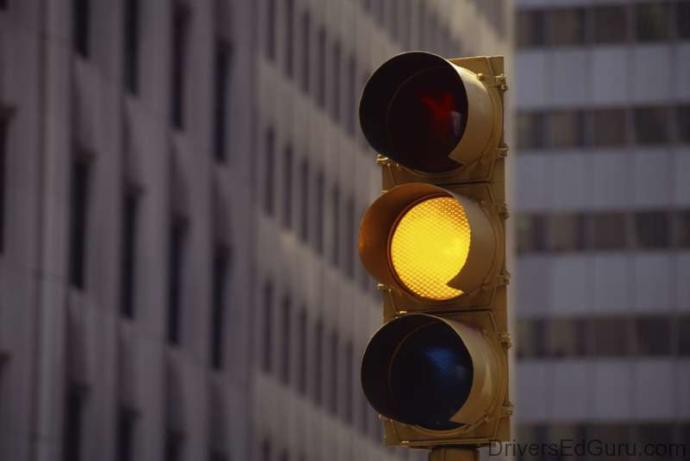 What do you do when you see a yellow traffic light?